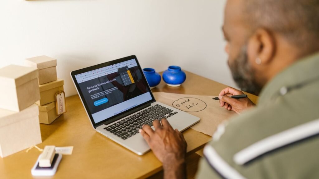 Business owner working on invoices at a laptop
